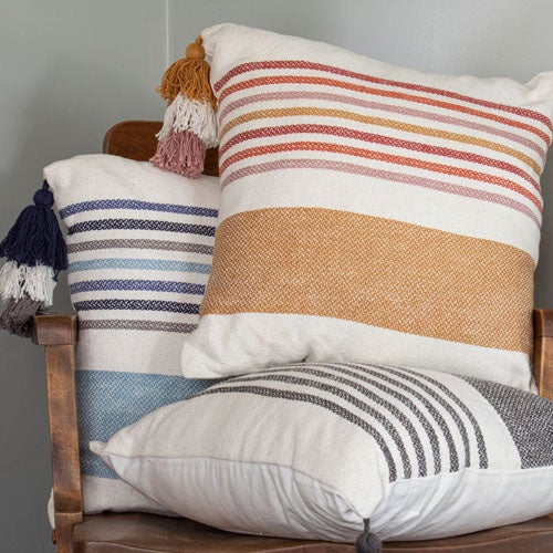 three cozy colorful pillows