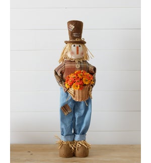 Scarecrow Holding A Basket Of Mums