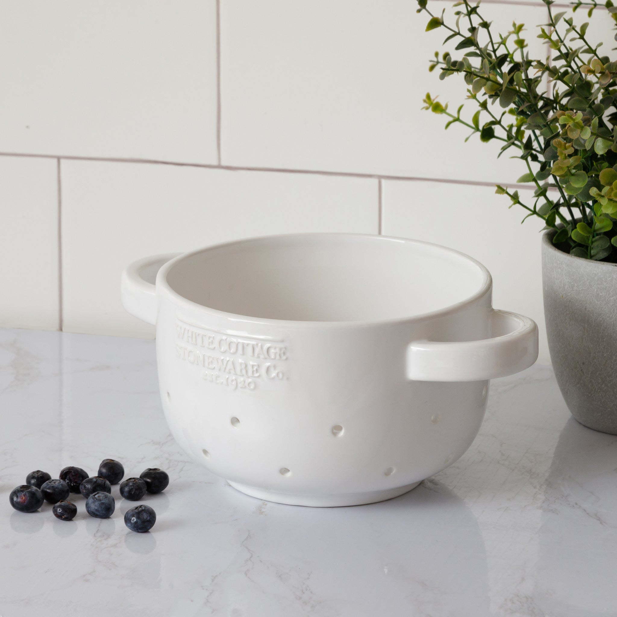 white ceramic berry colander