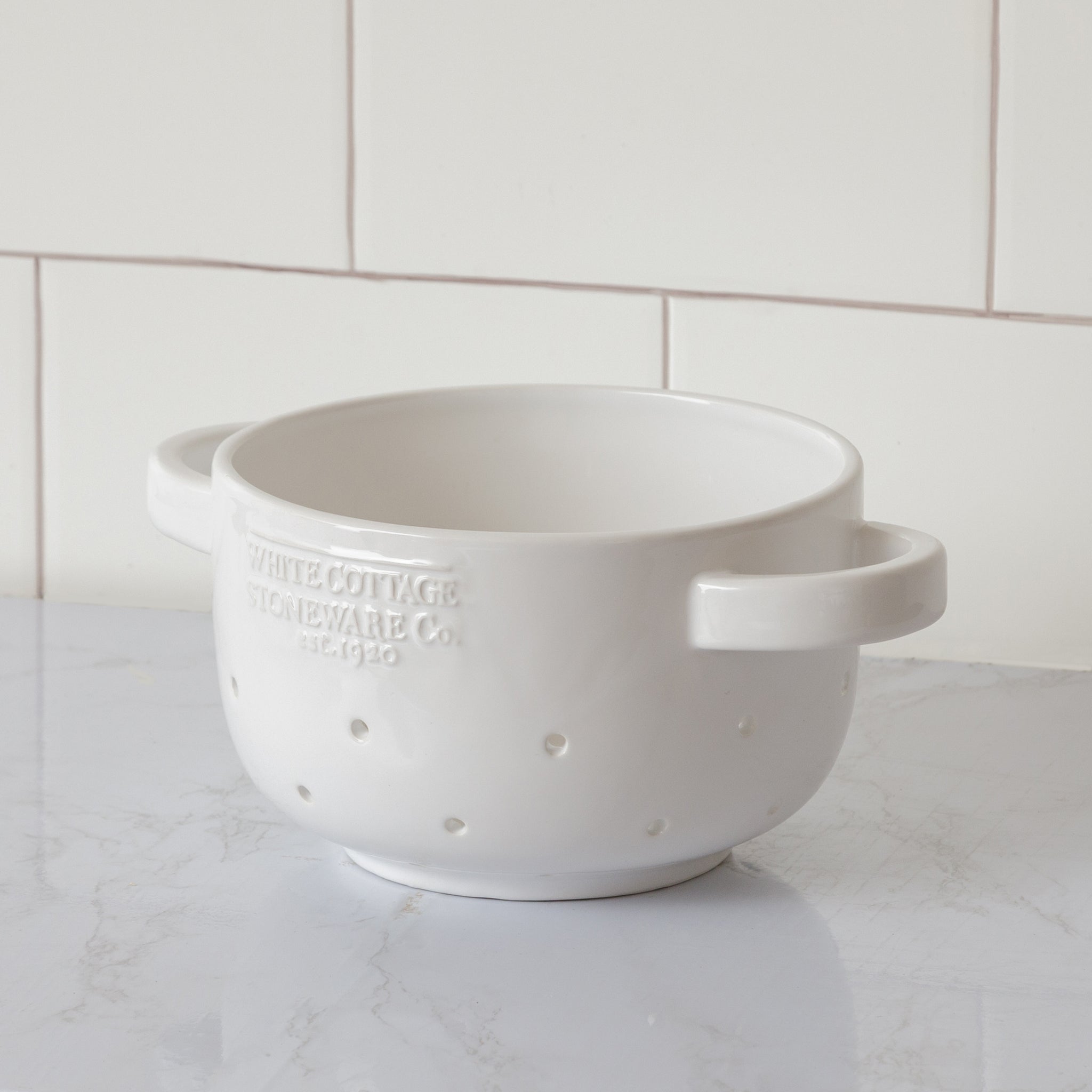 white ceramic berry colander