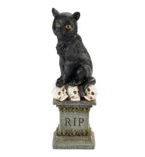 Cat on Tombstone with Skulls